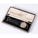 A gentleman's silver case wristwatch, the round engine turned dial with black Arabic numerals and