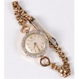 A lady's 18ct and diamond cased Recta wristwatch, the round off-white dial with gilt Arabic
