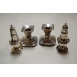A pair of early 20th century sterling silver pedestal pepperettes on loaded bases, together with a
