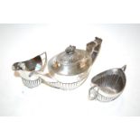 A George V bachelors three-piece silver teaset, of oval half-gadrooned form, maker Mappin & Webb,