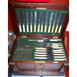 A George V oak cased 12 place setting canteen of silver plated cutlery bearing a label for