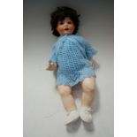 An early 20th century Simon & Halbig bisque head doll having rolling blue eyes, with open mouth