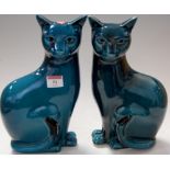 A pair of Poole pottery turquoise glazed models of seated cats, printed Poole England mark verso,