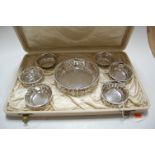 An early 20th century sterling silver bonbon set, having a central pierced circular bowl within