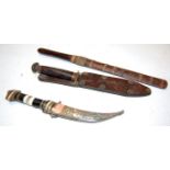 A British Commando fighting knife having a double edged blade and bound handle in leather sheath,