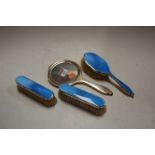 A George V silver and blue guilloche enamelled four piece dressing table set