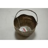 A circa 1900 continental silver basket having a wavy rim with embossed decoration to gadrooned base,