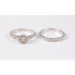 An 18ct white gold diamond halo ring and matching half hoop ring, the central round brilliant cut