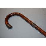 A circa 1900 bamboo walking cane having a silver collar and further silver mount, length 93cm