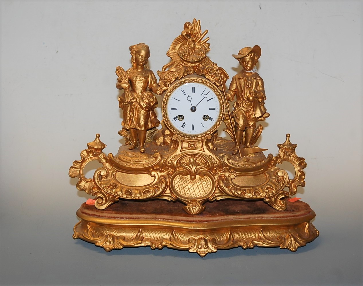 A late 19th century French gilt metal cased mantel clock, having enamelled dial with Roman