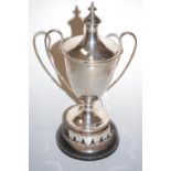 An Edwardian silver twin handled pedestal trophy vase and cover, with engraved inscriptions to