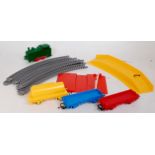 Parts of a Triang Hornby play train, green clockwork 0-4-0 tank engine, red, blue, flat wagons,