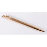 A 9ct gold propelling pencil, the engine turned body with tapered end, and hanging loop,