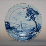 An 18th century Dutch Delft charger, typically blue & white decorated with sailing ship, dia. 34cm,