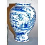 An 18th century Delft vase, underglaze blue decorated with a landscape, h.18cm (restored to rim)