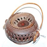 A Chinese carved and pierced bamboo(?) pot pourri, of squat circular form, with wooden loop handle