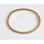 A 9kt gold hinged bangle, the plain 4mm wide hinged bangle, 6.4cm wide, with concealed clasp stamped