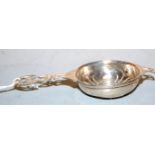 A George V silver strainer, having typical pierced bowl with further entwined piercded handle,