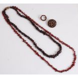 Two garnet bead necklaces, 66cm and 52cm long, together with two garnet style brooches (4)
