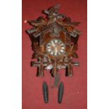 A late 19th century Continental carved softwood cuckoo clock