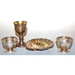 A pair of Victorian silver egg-cups, having embossed Celtic style and mask decoration, with gilt-