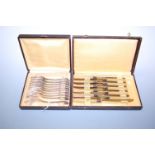 Ten cased silver plated dessert forks (originally twelve); together with eleven table knives, having