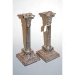 A pair of early 20th century silver plated Corinthian column table candlesticks, each having