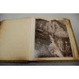 A 19th century leather bound photograph album and contents, mainly being European mountain scenes