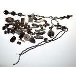 A collection of assorted Whitby jet to include brooches, necklace, etc