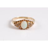 An 18ct opal and diamond ring, the oval opal cabochon, set to either side with mixed cut diamonds,