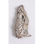 A mid 20th century silver brooch of a woman in medieval dress, naturalistically modelled in long