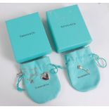 A Tiffany silver heart pendant necklace, and a Tiffany key charm, both cased and boxed (2)