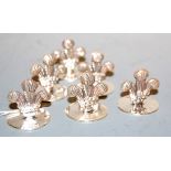 A set of six modern silver place setting holders, each in the form of a fleur de lys, maker E & J,