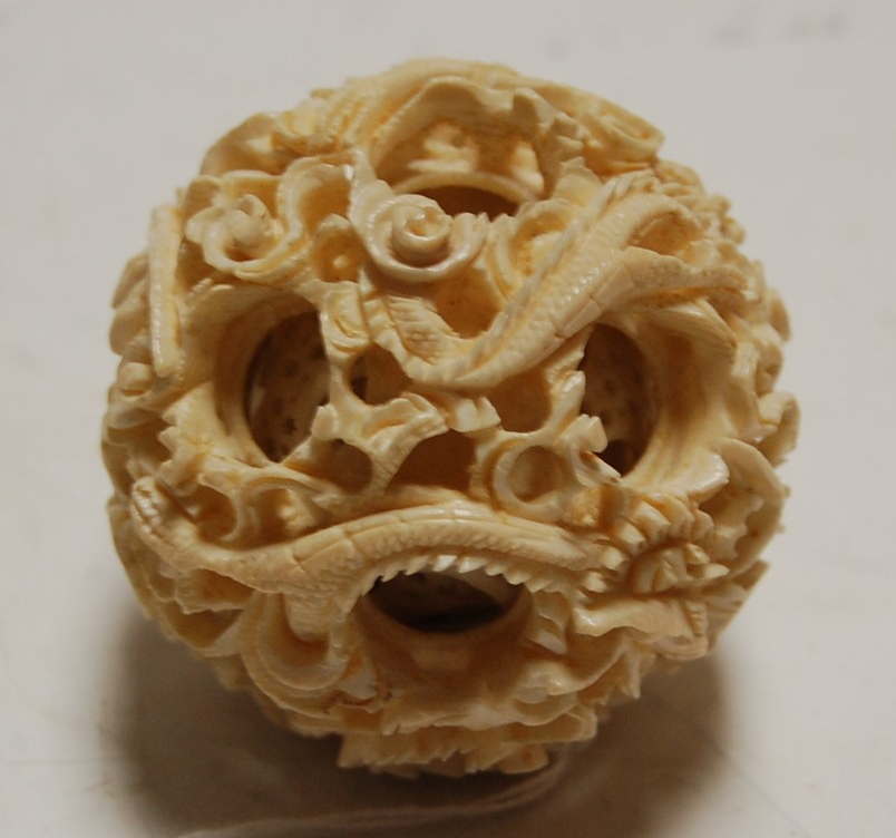 An early 20th century Chinese carved ivory puzzle ball, dia. 6.5cm