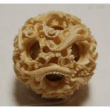 An early 20th century Chinese carved ivory puzzle ball, dia. 6.5cm