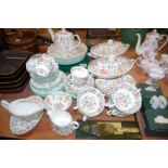 A Mintons part tea and dinner service in the Haddon Hall pattern to include boxed napkin rings and