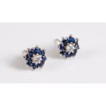 A pair of 18ct sapphire and diamond earstuds, the central round brilliant cut diamond, each