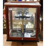 A set of laboratory scales in glazed mahogany case, bearing a label for Sartorius Werke,