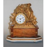 A late 19th century French gilt metal cased mantel clock, having enamelled dial with Roman numerals,