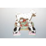 A pair of Staffordshire cat figures, each sat upon a cushion and with sponged decoration, h.10cm;