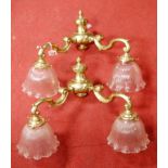 A pair of twin branched brass light fittings with ribbed glass frilled shades