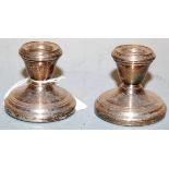 A pair of modern silver dwarf candlesticks on loaded bases, h.5cm