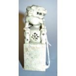 A modern Chinese carved soapstone desk seal surmounted by mythical creatures, height 11.5cm