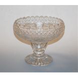 A large 19th century cut glass pedestal bowl, having wavy rim to a tapered stem and star cut base,