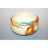 A Clarice Cliff Newport Pottery fruit bowl, decorated in shades of yellow, orange, brown and