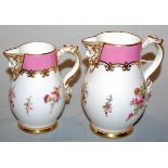 A pair of graduated porcelain mask jugs, each decorated in bright enamels with floral sprays,