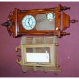 A reproduction mahogany cased wall clock; together with a modern glazed beech hanging wall cabinet