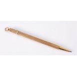 A 9ct gold propelling pencil, the engine turned body with tapered end, and hanging loop,