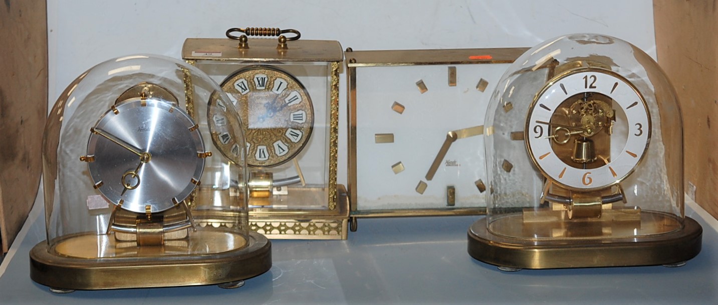 A Kundo electronic brass cased mantel clock together with three others (4)