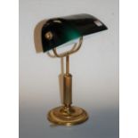 A lacquered brass desk lamp, with adjustable green glass shade